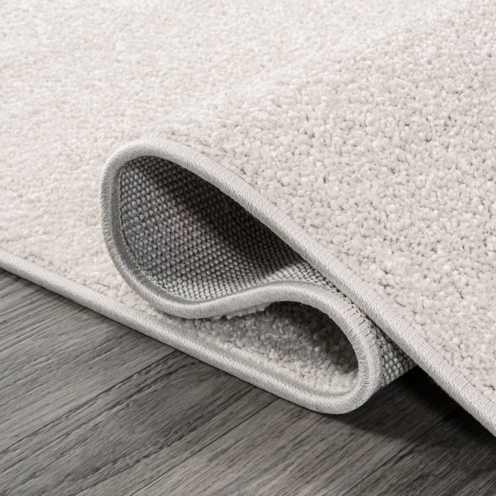 Haze Solid Low-Pile Ivory 5 ft. x 8 ft. Oval Area Rug