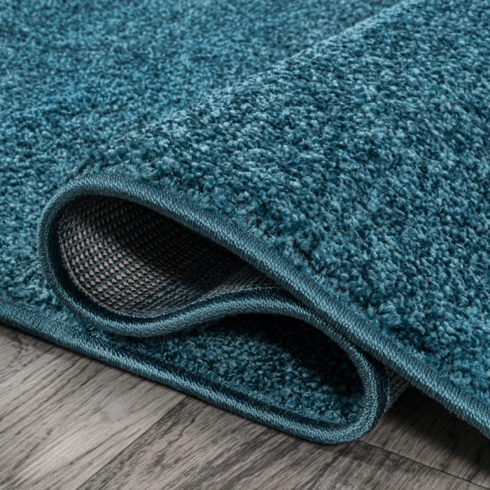 Haze Solid Low-Pile Turquoise 6 ft. x 9 ft. Oval Area Rug